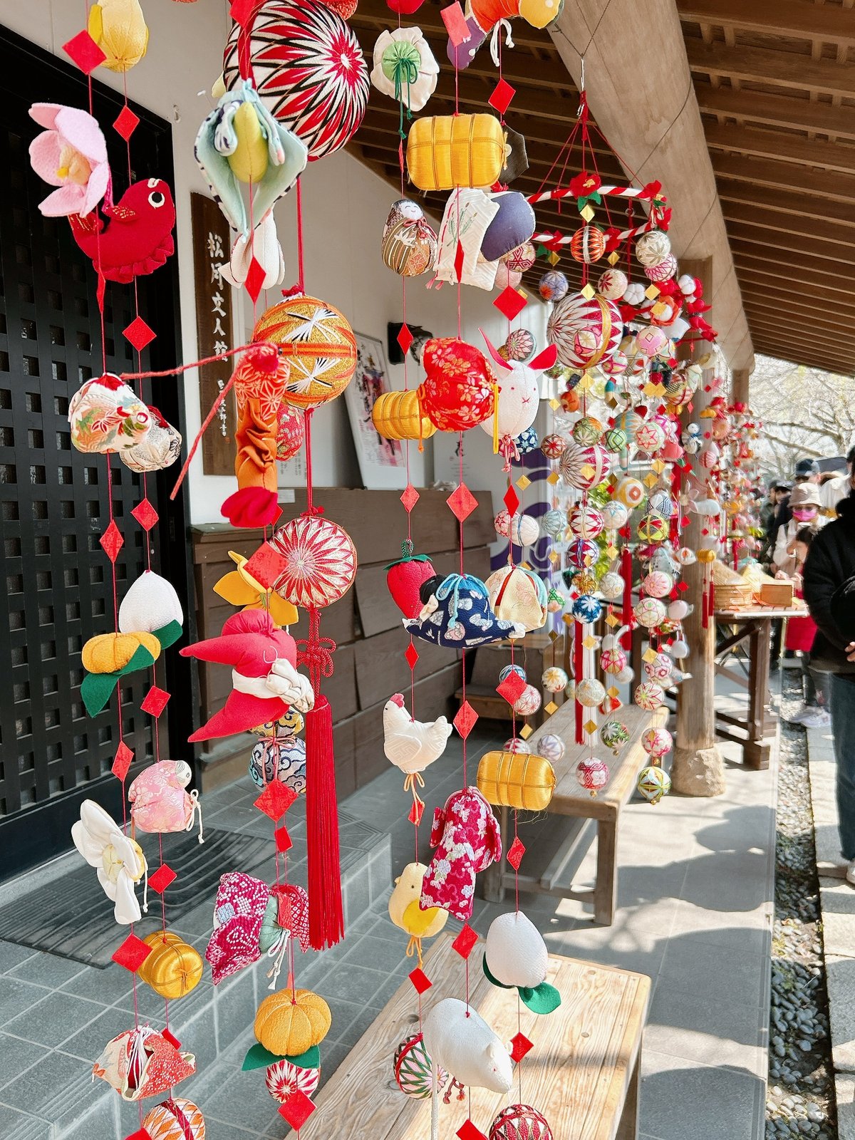 Hanging silk tsurushi-bina decorations, densely coloured, at a heritage house